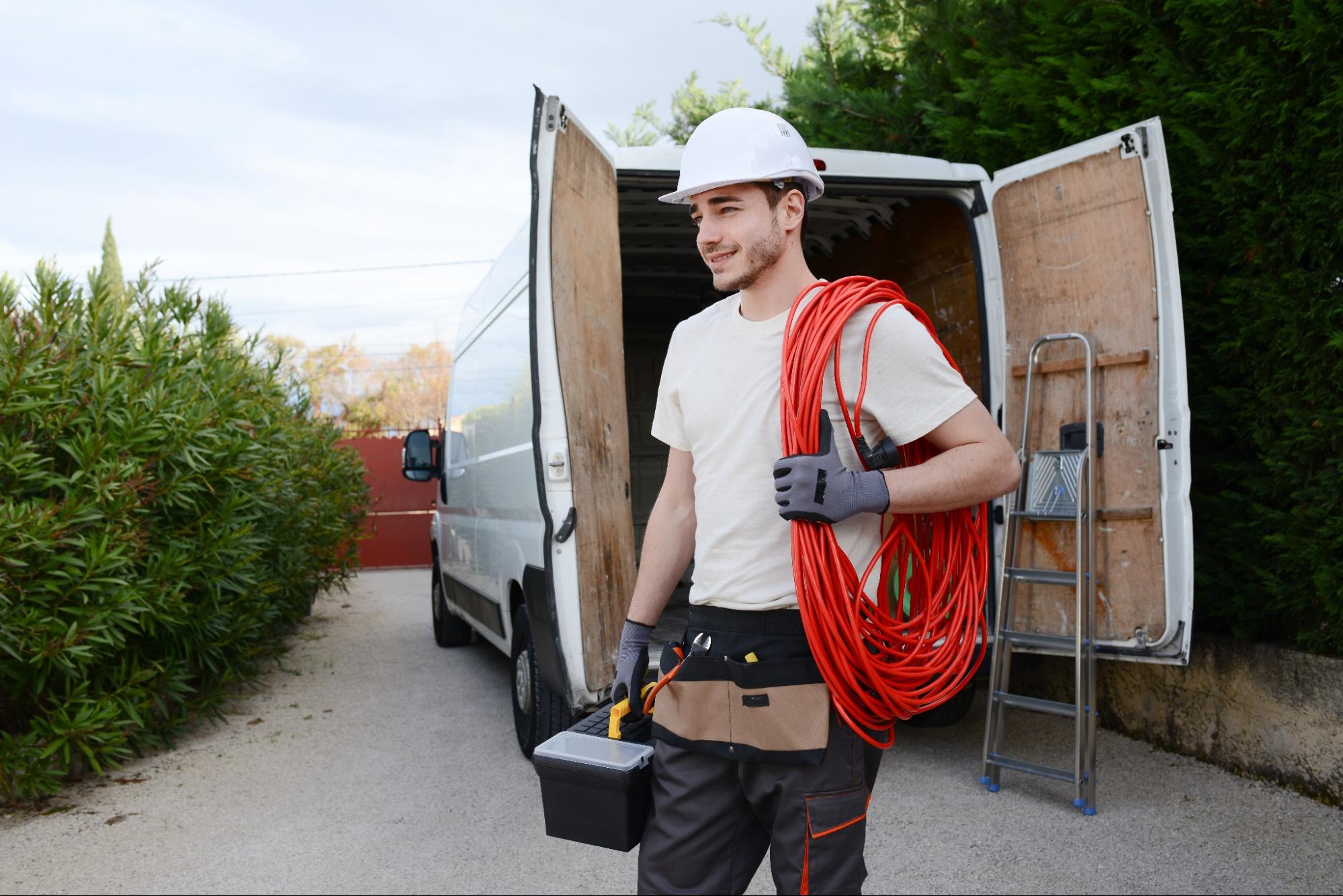 Electrical worker carrying wire