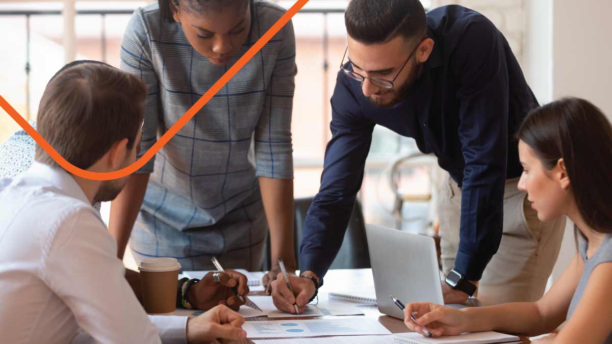 Group of people writing on documents
