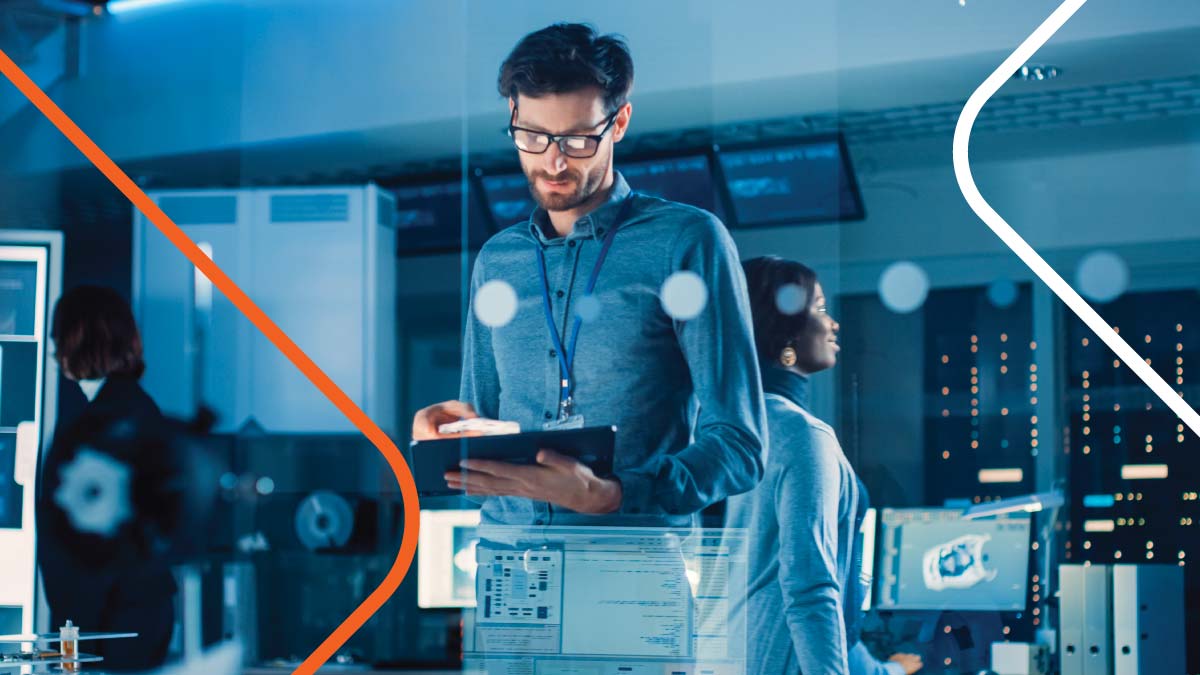 Man in blue shirt with tablet working in security room